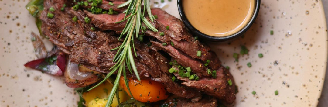 sliced ostrich with roasted veggies and herbs