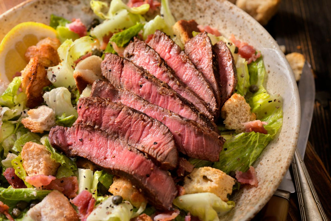 Ostrich filet slices served over a fresh salad