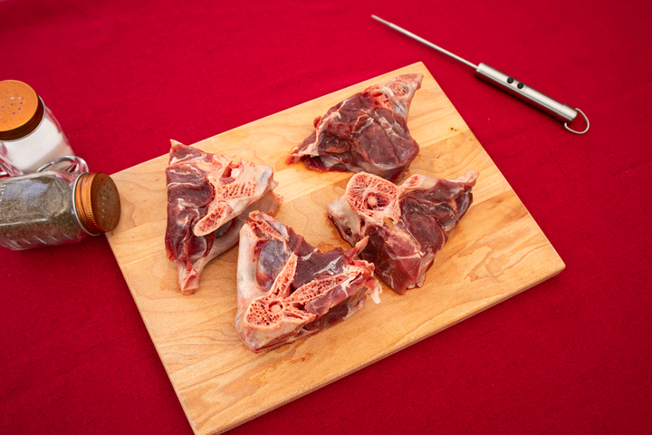 raw rib chops on a cutting board